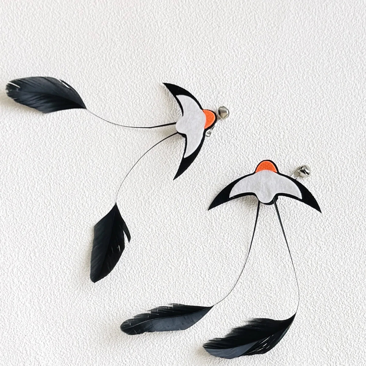 Feather Wand Refills in Black — two refills on a textured cream surface