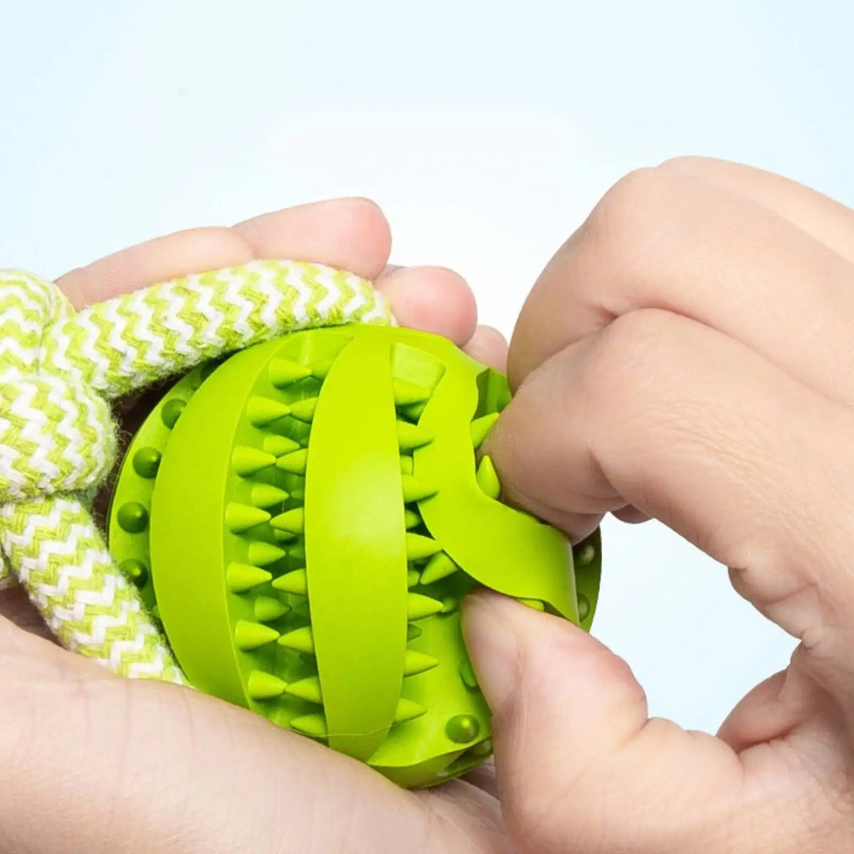 Rope Tug Toy in Sage — hands holding the textured treat ball