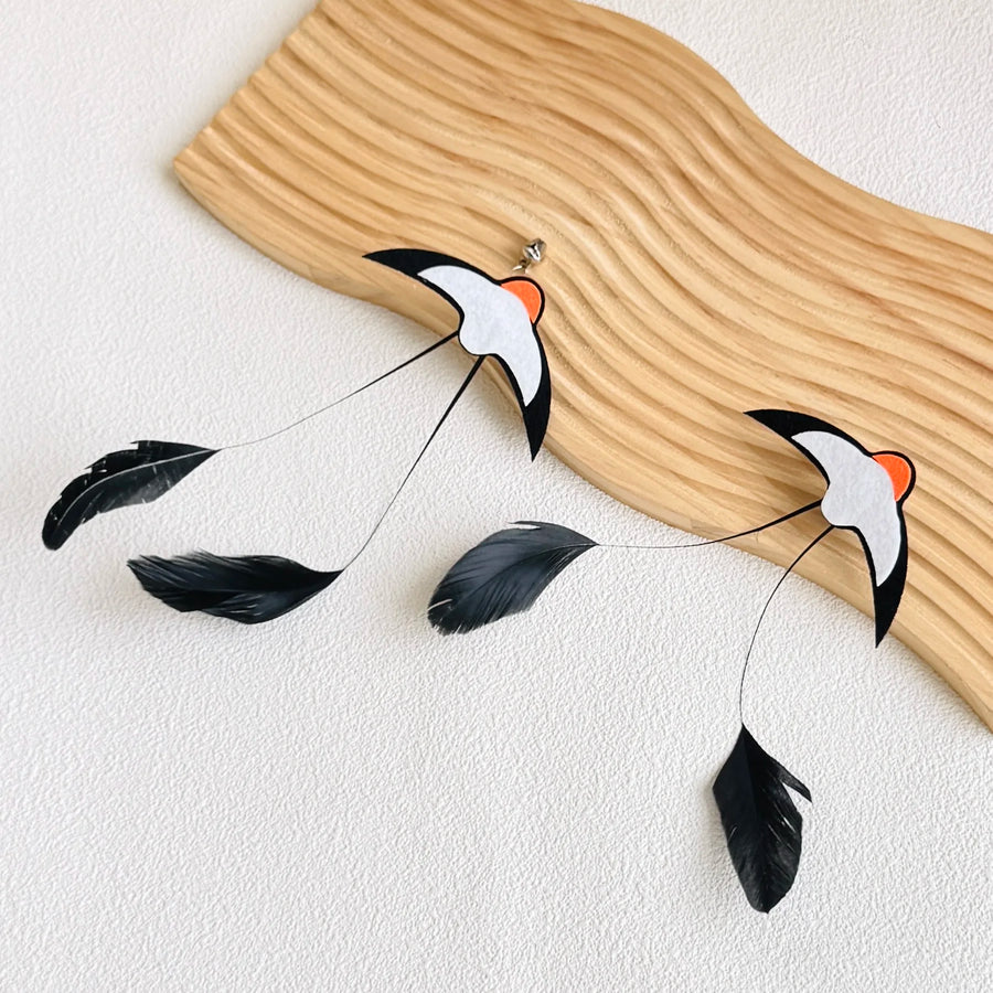 Feather Wand Refills in Black — two refills on a sculpted wooden board