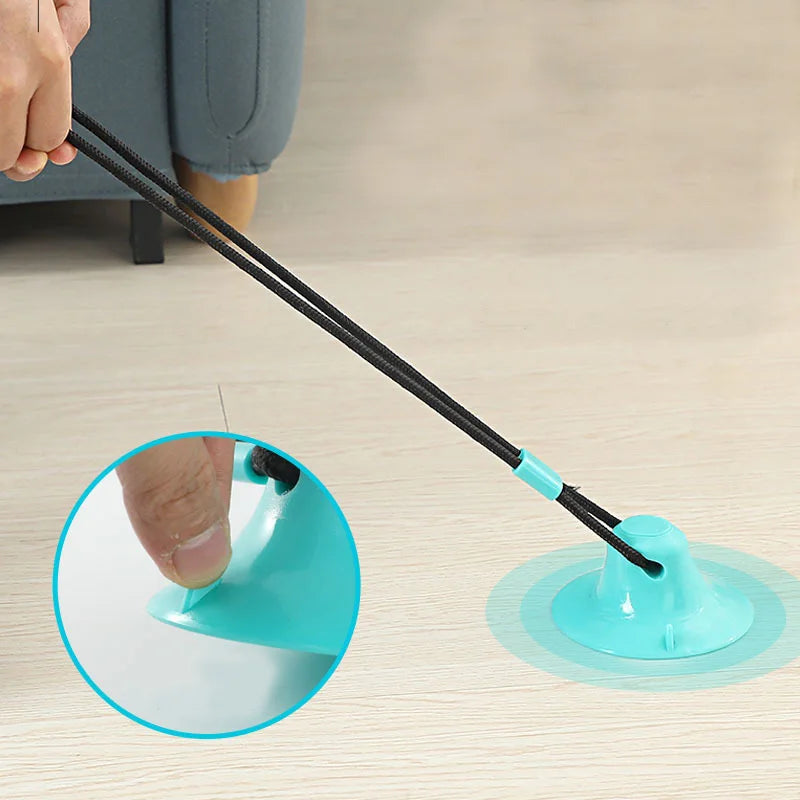 Rubber Treat Toy in Blue — pressing the suction base onto the floor