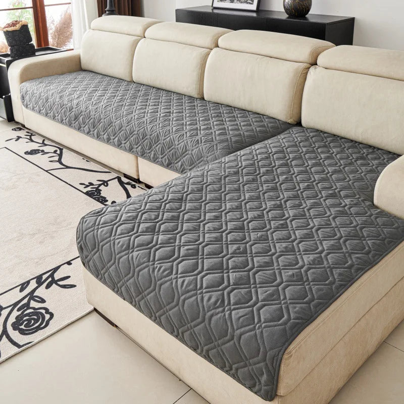 Quilted Sofa Protector in Charcoal — covering the seats of a cream sectional sofa