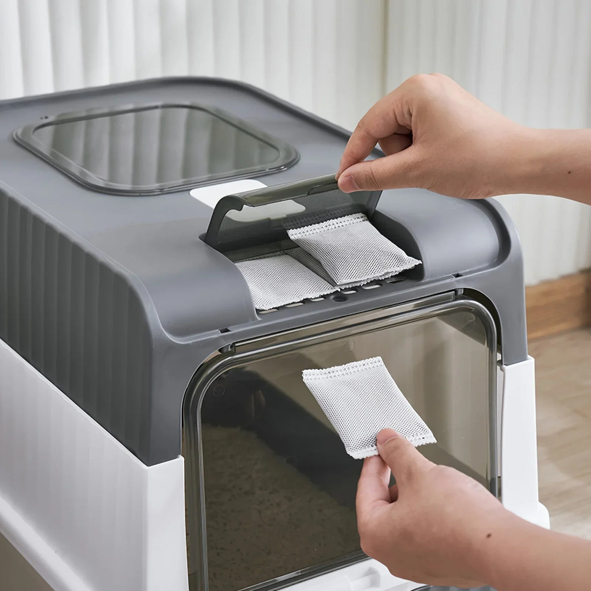 Enclosed Litter Box in Stone — top compartment opened to add a carbon sachet