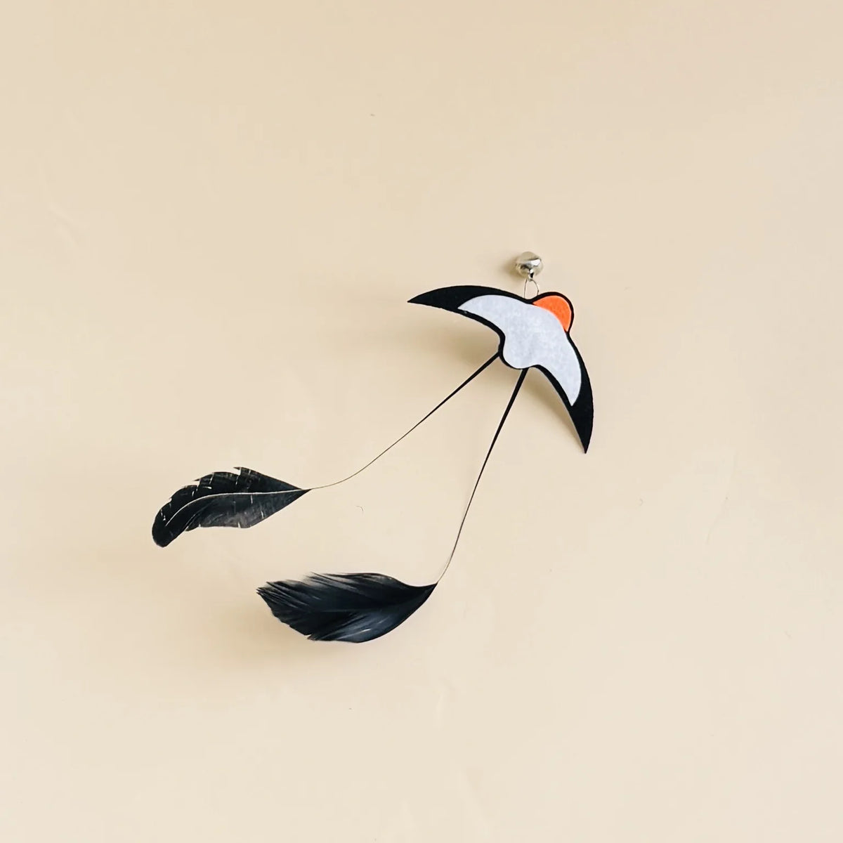 Feather Wand Refills in Black — single refill on a warm sand background
