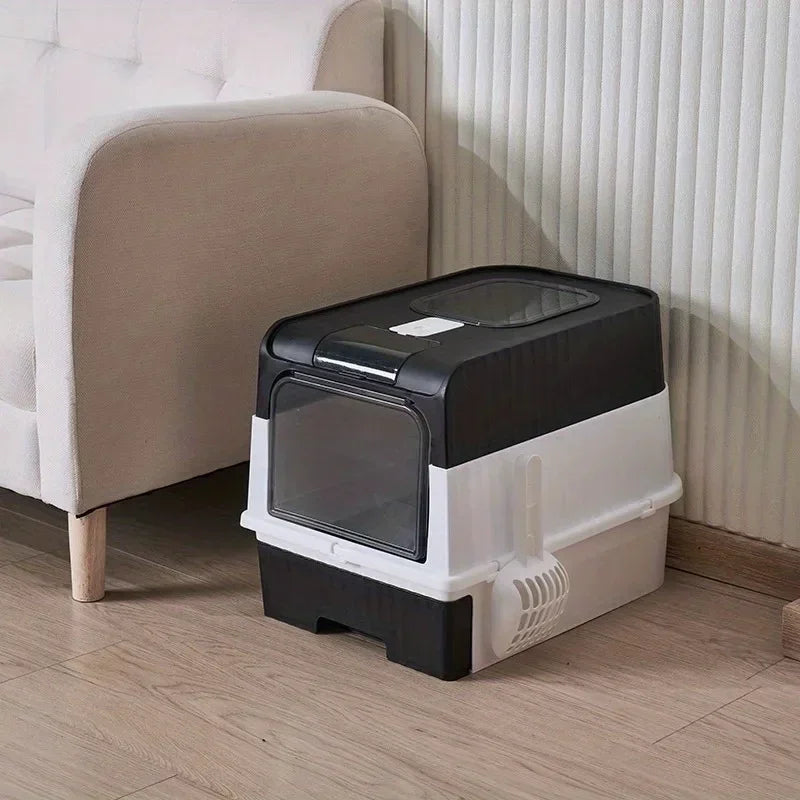 Enclosed Litter Box in Black — beside a sofa on a wood floor