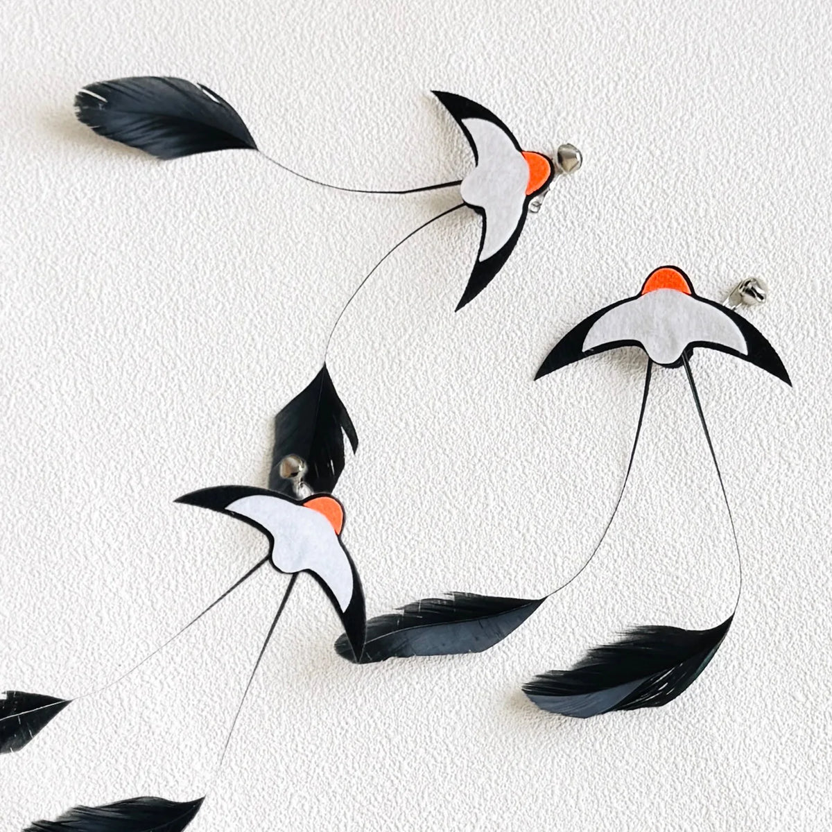 Feather Wand Refills in Black — set of three on a textured cream surface