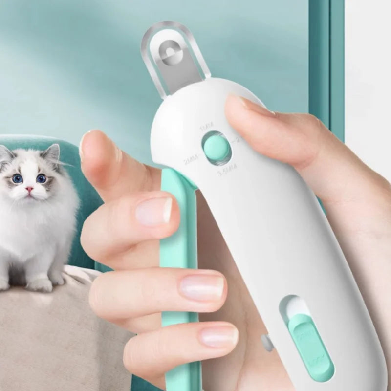 Safety Nail Clipper in Mint — held in hand with a cat nearby
