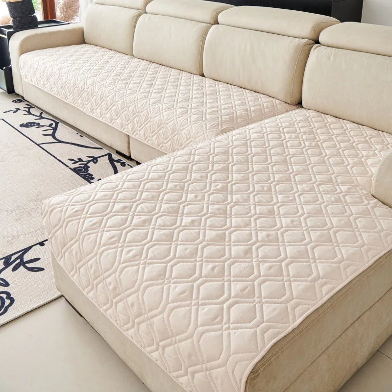 Quilted Sofa Protector in Sand — covering the seats of a cream sectional sofa