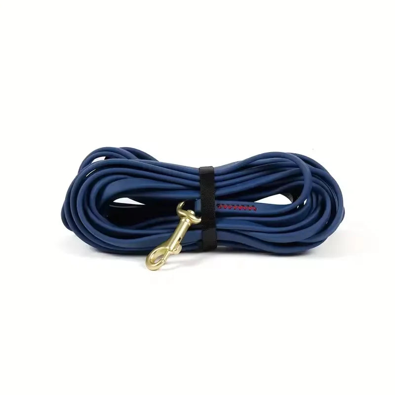 Coated Long Line Leash in Navy — coiled leash with brass-tone snap hook on a white background