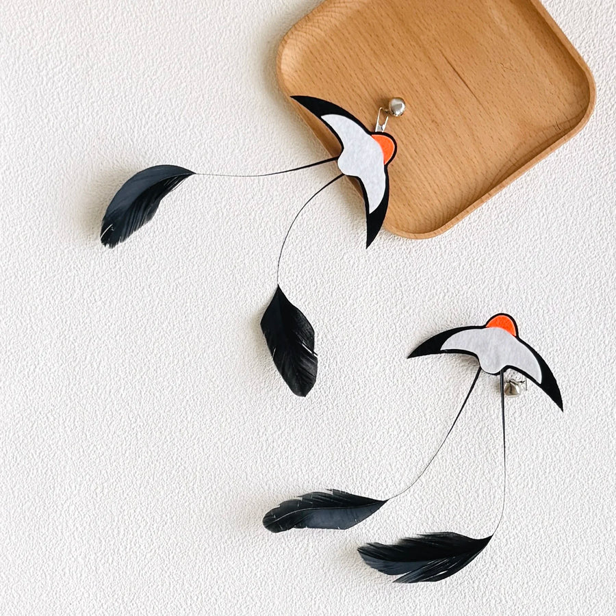 Feather Wand Refills in Black — two refills beside a wooden tray