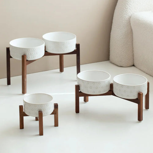 Raised Ceramic Feeder in Cream — single and double wood stands styled in a bright living room