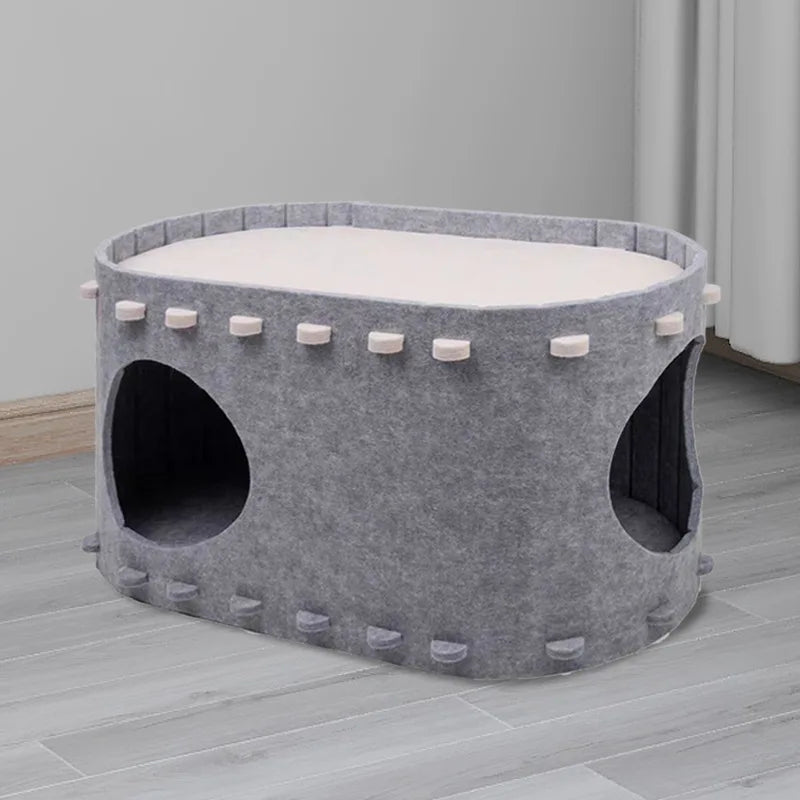 Felt Cat Cave in Mist — two-tier cave with round openings on a light wood floor